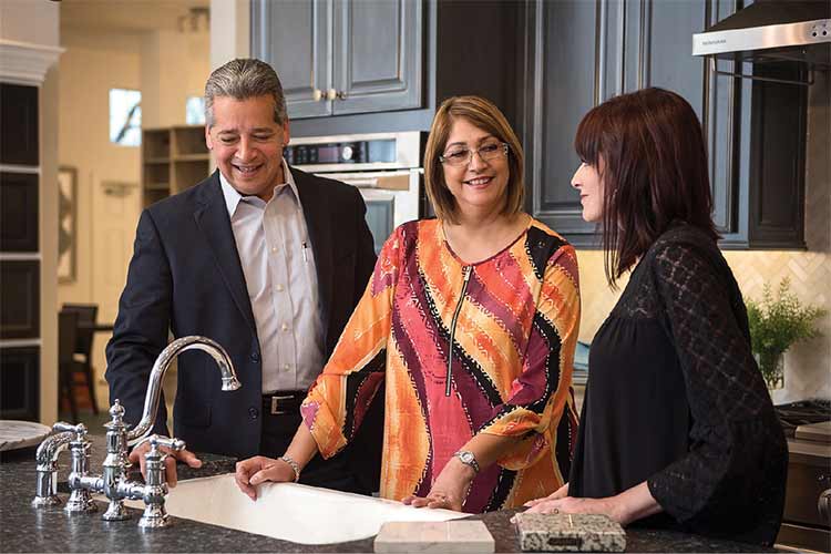 A David Weekley Homes Design Consultant showing customers kitchen options