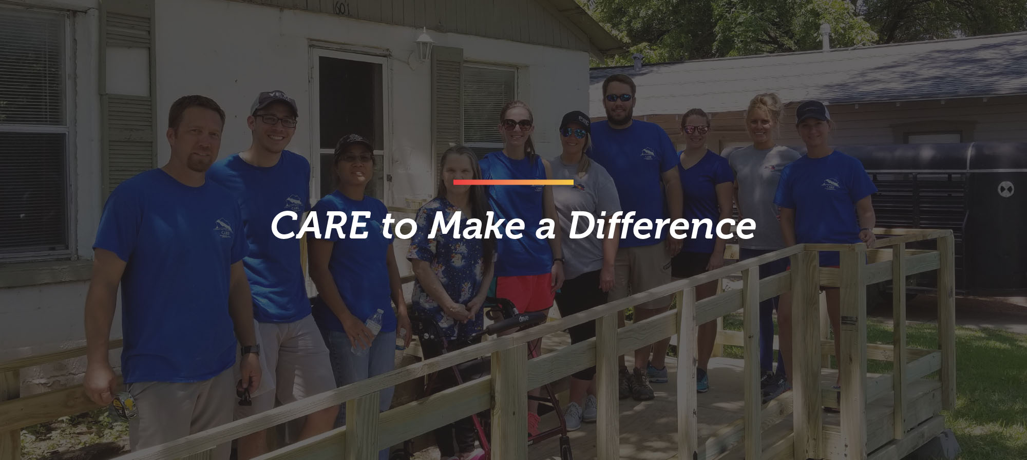 a group of David Weekley Homes Team Members stand on a wheelchair ramp that was built during a CARE event