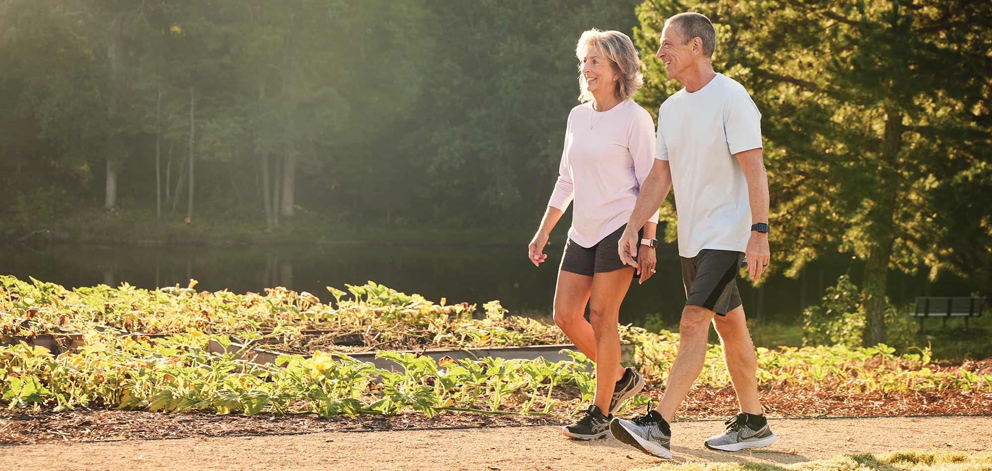 a man and a woman walk along a trail