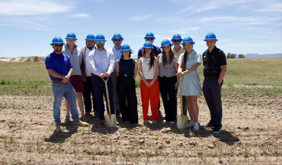 people standing with shovels at a ground breaking ceremony