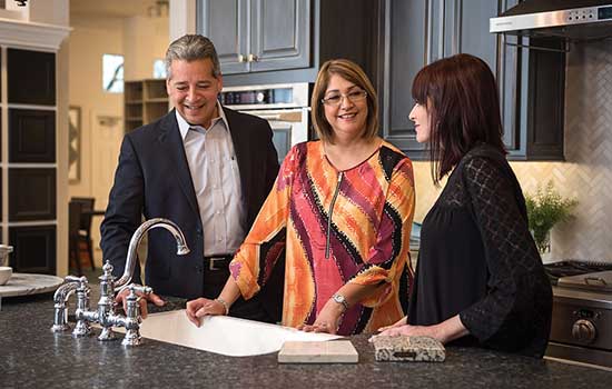 Design Consultant with Customers looking at kitchen counter options