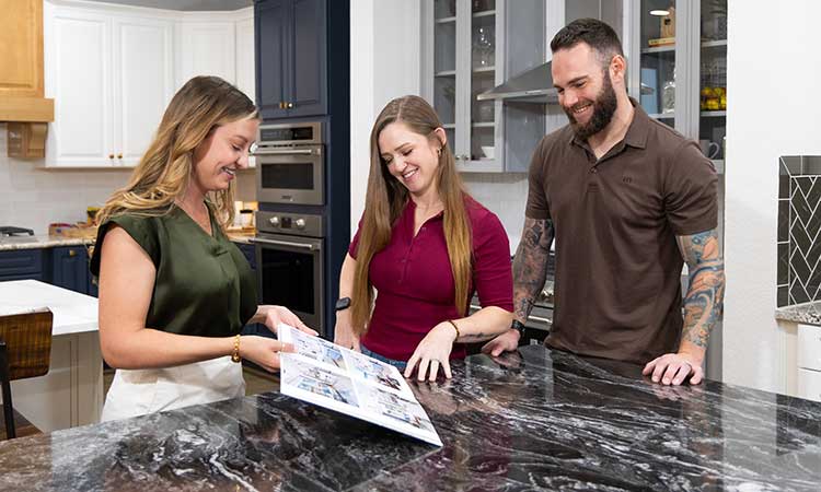 A David Weekley Homes Design Consultant shows color samples to cusomters