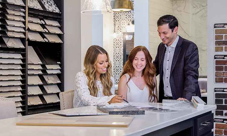 A David Weekley Homes Design Consultant shows customer kitchen options