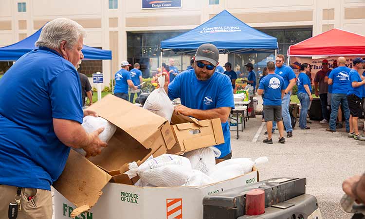 David Weekley Homes Team Members sorting food donations at a past Thanksgiving Drive in Tampa, FL