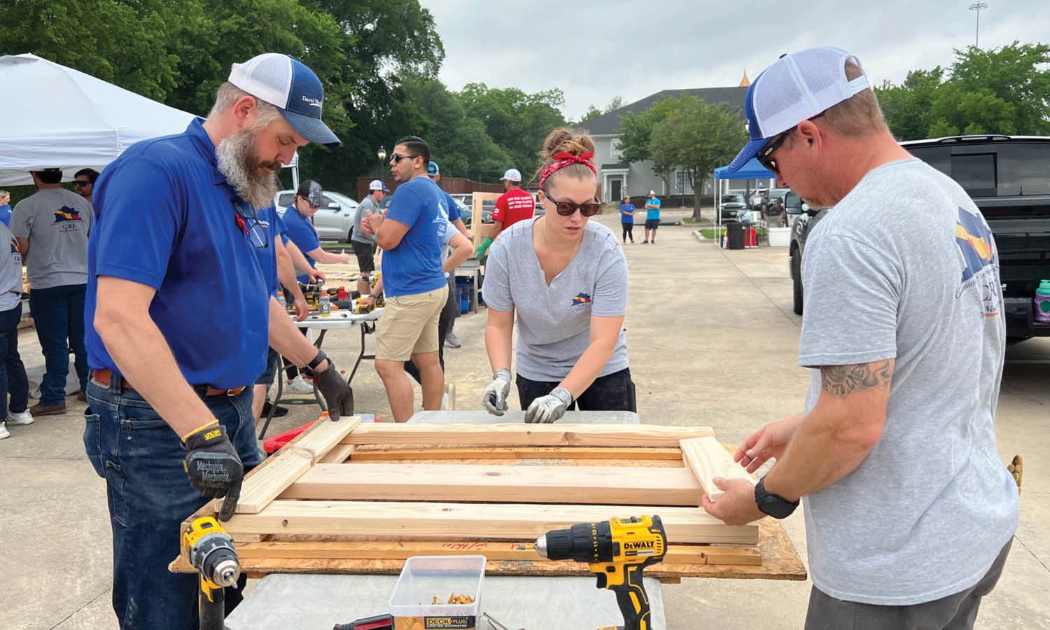 Three David Weekley Homes Team Members contructing wood bed frames