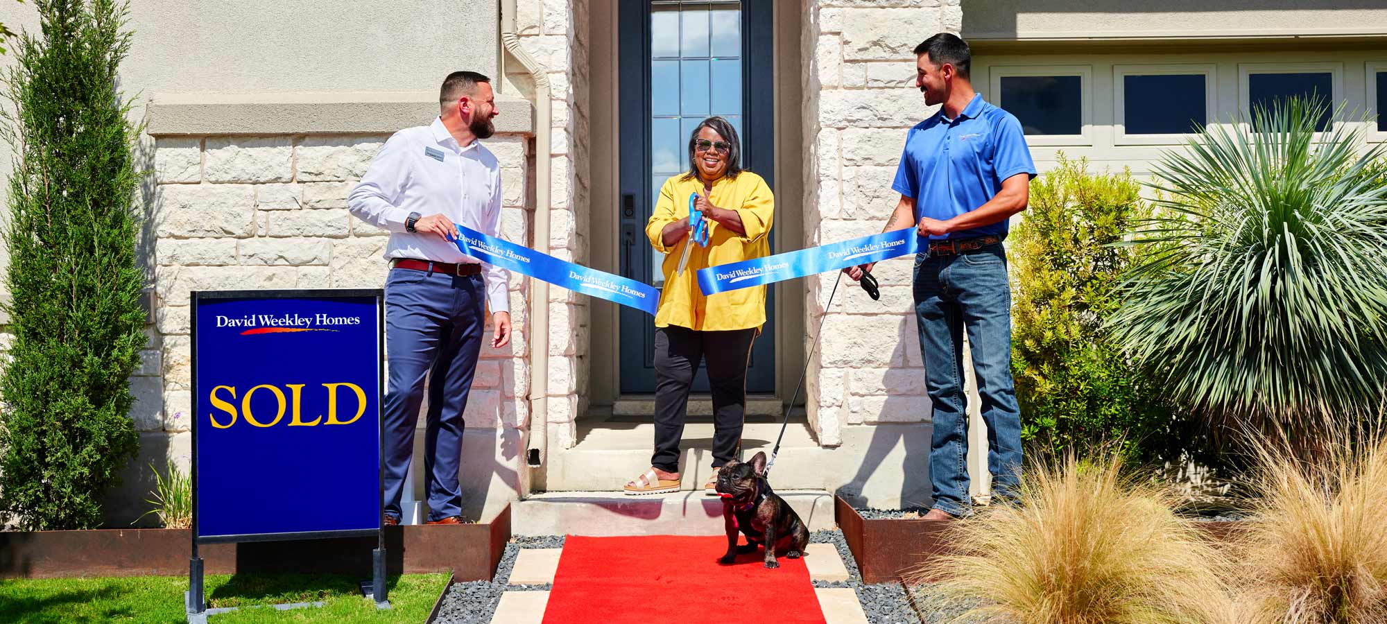 A David Weekley Homes Sales Consultant and Personal Builder welcome a woman to her new home