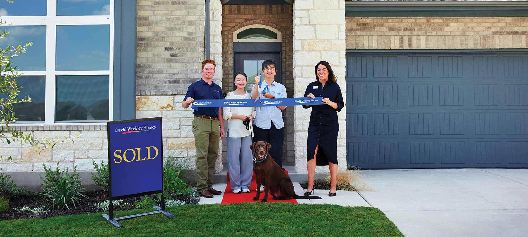 A David Weekley Homes Sales Consultant and Personal Builder welcome a family to their new home