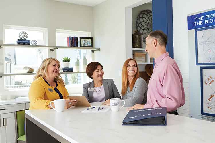 David Weekley Homes Team Members sitting at a counter and talking